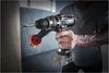 A person is using a cordless drill to drill into a piece of wood. Sawdust is flying. Produktbild-Vorschau