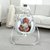 A baby is sitting in a baby swing in a living room. Produktbild-Vorschau