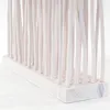 A close-up view of a white wooden room divider made of vertical sticks. Náhľad obrázku produktu