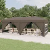 A brown party tent set up outdoors on a patio with tables and chairs inside. Produktbild-Vorschau