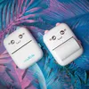 Two white mini printers with cute cartoon faces are placed on a background of colorful tropical leaves. Produktbild-Vorschau