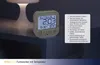 A digital alarm clock with temperature display sits on a nightstand next to a lamp. Anteprima dell’immagine prodotto