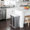 A modern kitchen with a stainless steel trash can in the foreground. Podgląd zdjęcia produktu