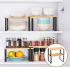 A kitchen cabinet shelf with organizers holding various kitchen items. Produktbild-Vorschau