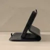 A black leather phone case with a stand function is displayed in a side profile. Produktbild-Vorschau