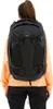 A woman wearing a black Osprey travel backpack. Produktbild-Vorschau