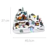 A miniature Christmas village scene with a house, trees, and people. Náhľad obrázku produktu