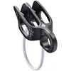 A black climbing belay device with a white rope loop attached. Náhľad obrázku produktu