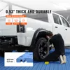 A person is working on a white pickup truck in a garage, with blue interlocking floor tiles visible. Podgląd zdjęcia produktu