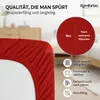 Close-up of a red fitted sheet with text and icons highlighting product features. Produktbild-Vorschau