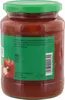 A close-up of a glass jar filled with a red preserve, likely a vegetable relish or sauce, with a green lid. Produktbild-Vorschau