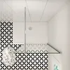 A top-down view of a modern bathroom shower enclosure with patterned tiles. Produktbild-Vorschau