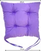 A square purple seat cushion with ties. Produktbild-Vorschau