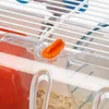 A close-up view of a plastic clip on a white wire cage, likely for a small pet. Produktbild-Vorschau