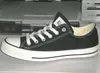 A black Converse All Star shoe is shown in profile on a light gray and white surface, with a printer or scanner in the background. Anteprima dell’immagine prodotto