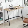 A modern home office setup with a wooden desk and black legs, featuring a laptop, phone, and decorative items. Náhled obrázku produktu