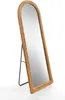 A full-length mirror with a woven wicker frame and a black metal stand, shown against a white background. Náhled obrázku produktu