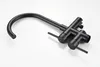A black freestanding bathtub faucet with a handheld showerhead, shown against a white background. Produktbild-Vorschau