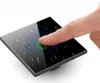 A finger touching a black glass light switch with water droplets on it. Anteprima dell’immagine prodotto
