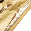 A close-up shot of a gold fabric surface with a textured weave and reflective highlights. Podgląd zdjęcia produktu