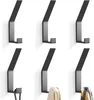 Six black metal wall hooks arranged in two rows of three. Produktbild-Vorschau