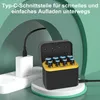 A battery charger case with AA and AAA batteries inside, connected to a power adapter via a USB-C cable. Produktbild-Vorschau