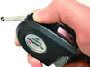 A hand is holding a black measuring tape with a silver tape extended. Anteprima dell’immagine prodotto