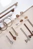 A collection of bathroom hardware in various finishes, laid out on a neutral surface. Anteprima dell’immagine prodotto