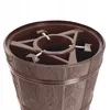 A close-up view of the top of a brown Christmas tree stand designed to look like a barrel. Voir les images du produit
