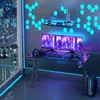 A modern gaming desk setup with multiple monitors, a computer, and decorative lighting. Voir les images du produit