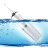 A white electric water flosser with a clear water reservoir is partially submerged in blue water, with bubbles visible. Náhľad obrázku produktu