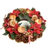A Christmas wreath with candles, pinecones, red flowers, and berries. Podgląd zdjęcia produktu