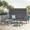 An outdoor lounge set with a canopy, placed on a patio next to a swimming pool. Produktbild-Vorschau