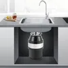 A cross-section view of a kitchen sink with a garbage disposal unit installed underneath. Produktbild-Vorschau