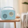 A retro-style blue radio sits on a wooden table next to a couch. Produktbild-Vorschau