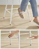 Close-up view of a person's legs and feet using a white bar stool, with inset images showing assembly and cleaning. Náhled obrázku produktu