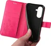 A hand is holding open a pink flip phone case, revealing the black interior where a phone would be placed. Produktbild-Vorschau