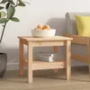 A wooden side table with a bowl of fruit and books on it, next to a couch and a plant. Produktbild-Vorschau