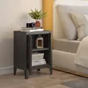 A bedside table next to a bed. Náhled obrázku produktu