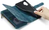 A hand is shown inserting a phone into a blue leather wallet-style phone case. The case has card slots and a zippered compartment. Produktbild-Vorschau