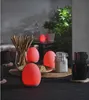 A table setting with egg-shaped lamps, breadsticks, cheese, and mugs. Produktbild-Vorschau