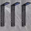 Three identical black shower panels are shown side-by-side, each demonstrating different water flow settings. Náhled obrázku produktu
