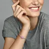 A woman's arm wearing a bracelet with a pink flower charm. Produktbild-Vorschau