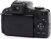 The back view of a black Canon PowerShot digital camera. Produktbild-Vorschau