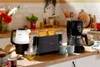 A kitchen counter with breakfast appliances and food. Produktbild-Vorschau