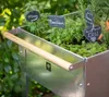 A close-up of a metal raised garden bed filled with herbs, with slate plant markers. Produktbild-Vorschau