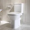 A white toilet in a tiled bathroom. Podgląd zdjęcia produktu