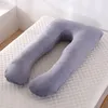 A U-shaped pregnancy pillow is laid out on a white mattress. Náhled obrázku produktu