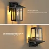 Two images of a black outdoor wall lamp, one showing it mounted facing downwards and the other facing upwards. Text overlays provide installation instructions. Produktbild-Vorschau