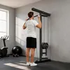 A man is exercising in a gym with a lat pulldown machine. Produktbild-Vorschau